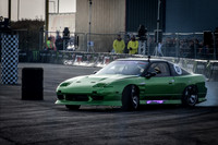 A Green Nissan 180sx S13 Drift Car doing Gymkhana at Santa Pod