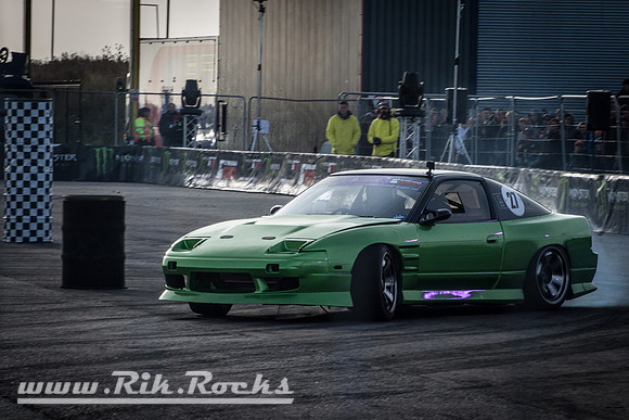 A Green Nissan 180sx S13 Drift Car doing Gymkhana at Santa Pod
