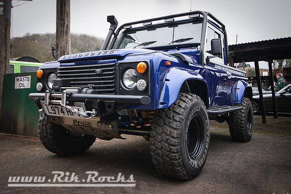A lifted, blue, Land Rover Defender Pickup, Reg: L974HFV